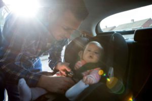 About Us - Putting child in car seat