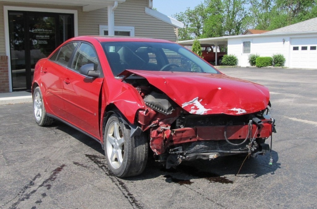 North Oaks Collision Specialists damaged car
