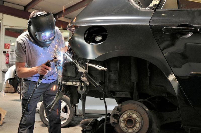 wayne auto repair tech welding on car