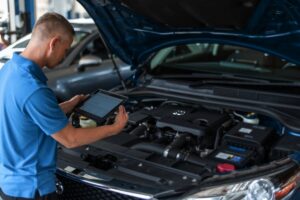 Mechanic doing a diagnostic on vehicle-Marion Collision Shop